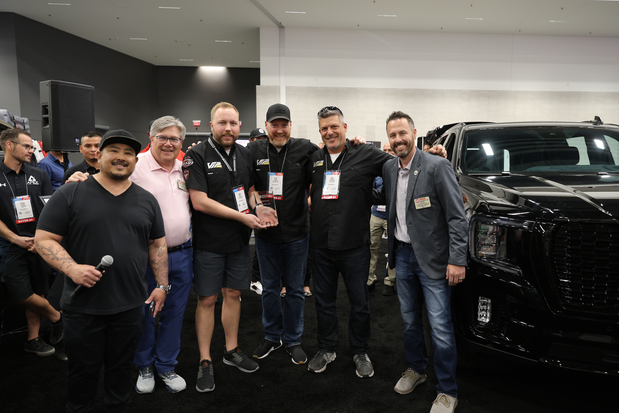 VIP Distributing Company poses with the 2023 PRO Cup Challenge People’s Choice Award next to their GMC Yukon Denali