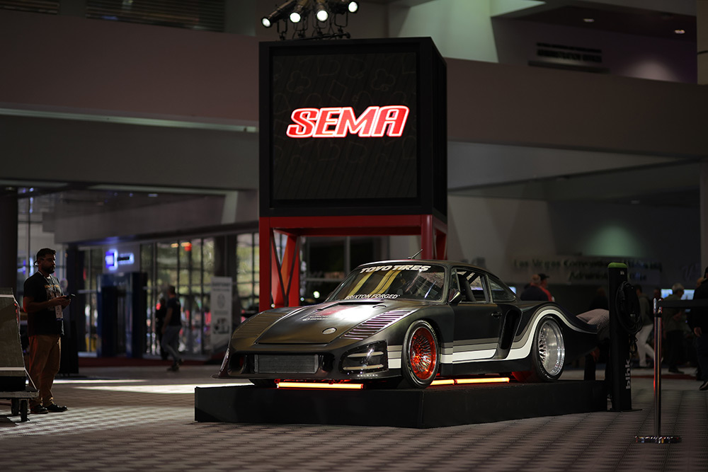 Porsche 911 on display at SEMA Show with interesting lighting.
