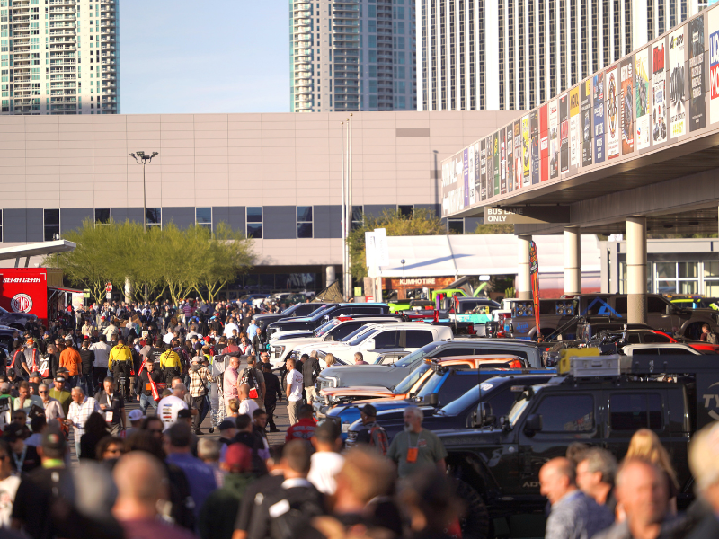 Crowd outside of SEMA Show convention center looking at feature vehicle displays