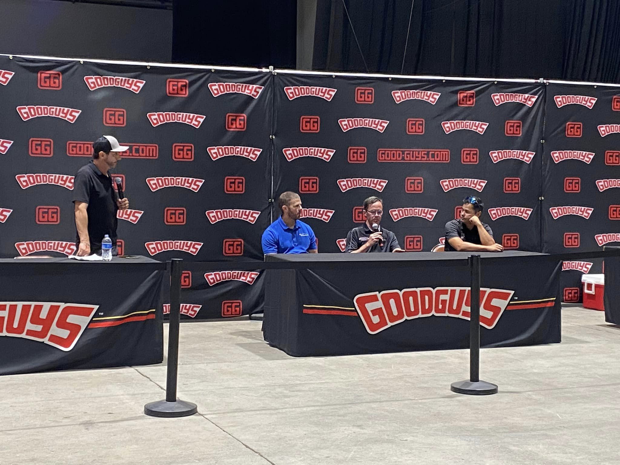 People sitting at a Goodguys table