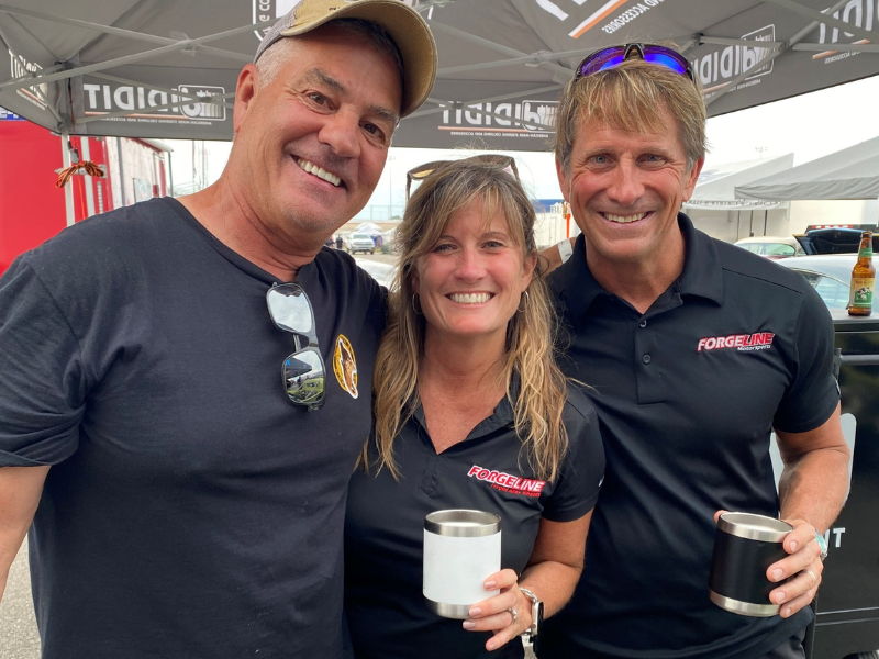 Three people smiling big for the camera