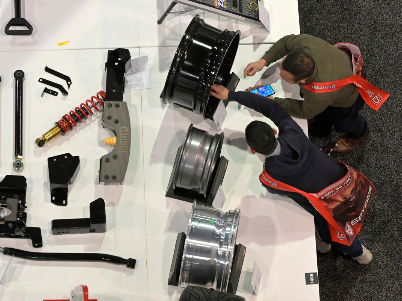 Overhead view of people examining wheels at the SEMA New Products Showcase