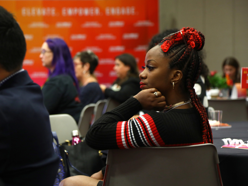 Lady listening to a presentation