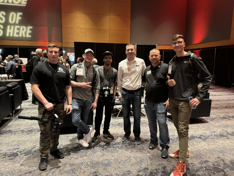 Group of guys smiling for the camera at a networking event.