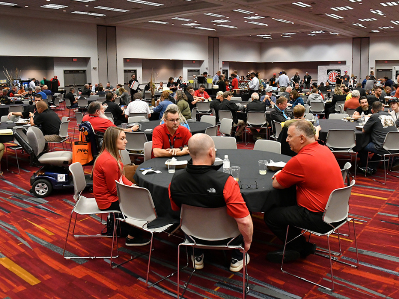 People sitting at tables in the Member Lounge area.