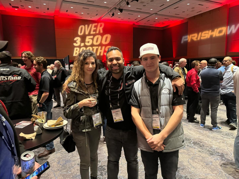 Group of attendees posing for a picture at the PRI Show