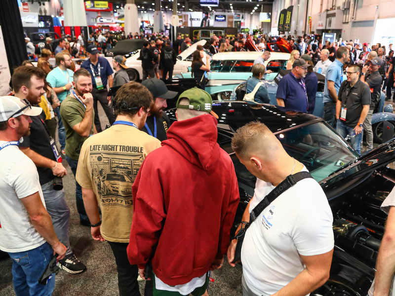 Show Attendees checking out the booth vehicles.