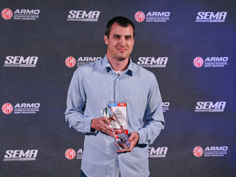 Representative from Max performance posing with the Business of the Year Award