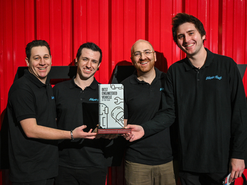 Award winners pose with trophy.