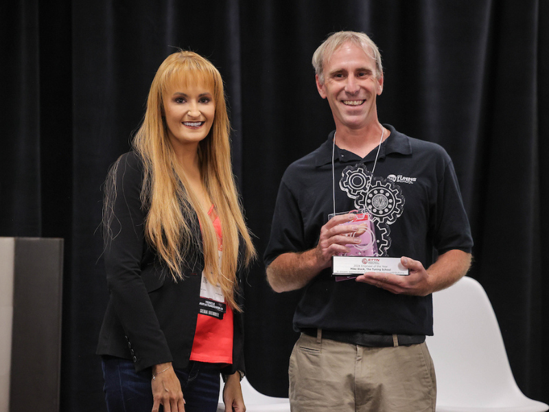 Mike Black smiling and holding Engineer of the Year award